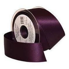 a roll of purple satin ribbon on a white background