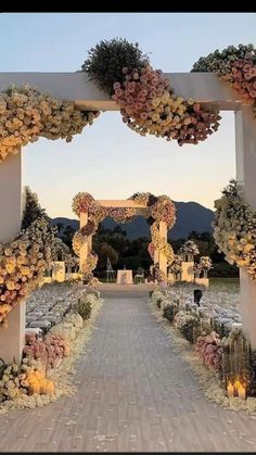 an outdoor wedding setup with flowers and candles