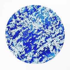 a blue and white circle with snow flakes on it's surface in front of a white background