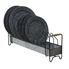 a set of six black granite dinner plates in a metal holder