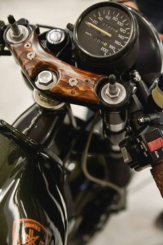 the handlebars and gauges on this motorcycle are made out of black wood