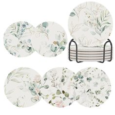 a set of four place settings with floral designs