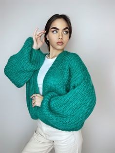 Incredibly beautiful, airy mohair cardigan is knitted by hand. An emerald green light cardigan from personally will suit any look as a cape. We knit this cardigan by hand in any color, you can find the colors in the photo and send us the number. It can be festive white or bright and rich. In any color palette, such a cardigan will look lush and voluminous. In the photo the model is 170 cm tall, size C, wearing a cardigan size XHL, color No. 477 - emerald green choose size: XS: Length 56-57 cm, Width 45 cm S: Length 57-58 cm, Width 50-54 cm M: Length 62 cm, Width 56-58 cm L: Length 62 - 63 cm, Width 60-61 cm XL: Length 62-63 cm, Width 62-64 cm XXL: Length 62-63 cm, Width 65-67 cm If you want to change something in your order or you have a non-standard figure, I can help you and make the car Coat Jacket Women, Wedding Cardigan, Bridal Shrug, Light Cardigan, Mohair Cardigan, Short Cardigan, Cardigan Women, Knitted Coat, Mohair Sweater