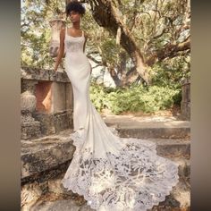 a woman in a wedding dress standing on some steps