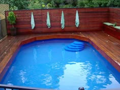 an above ground pool surrounded by wooden decking