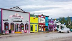 a row of brightly colored buildings on the side of a road