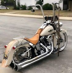 a white and tan motorcycle parked in a parking lot