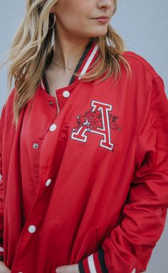 Another vintage inspired varsity jacket you're sure to love! This red vintage varsity jacket features red and black striped hem, cuff and collar, "ARKANSAS" across the back and a vintage HOG jumping through the Arkansas "A" on the front chest! It's the final (most essential) piece to your gameday outfit! 


Lili is 5'7" and is wearing size large for an oversized look 

Landon is 6'2" and is wearing size extra large

extra large measurements: 46" bust | 28" length


100% cotton 


WE ONLY OFFER S Vintage Varsity Jacket, Gameday Outfit, Arkansas, Black Stripes, Varsity Jacket, Trucker Hat, Vintage Inspired, Bomber Jacket, How To Wear