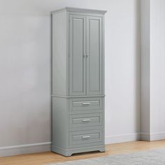 an empty room with a tall gray cabinet