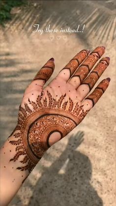 a woman's hand with henna tattoos on it