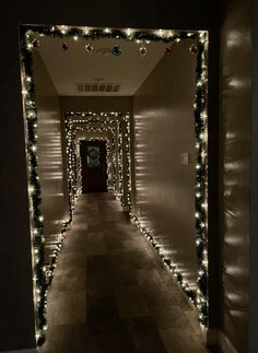 the hallway is decorated with christmas lights and garlands