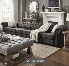 a living room filled with furniture and a fire place next to a couch in front of a fireplace