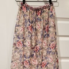 Nwt: Anthropologie-Raga Maxi Skirt Size Small Colors: Floral Print (Cream, Blue, Pink, Green Etc.) *Maxi Skirt *Tassel Drawstring Waist *Elastic Waistband *Detailing Bottom Tier *Light Weight *Flowy *Shell 100% Polyester *Lining 100% Cotton *Made In India Approx. Measurements Waist 11.75" Length 35" The Vibrant Pieces In The Raga Collection Celebrate The Connections Between The Family-Owned-And-Operated Label's Roots In India And Their Home Base In Venice Beach, Blending The Brilliant Colors And Feminine Beige Floral Print Bottoms, Feminine Beige Bottoms With Floral Print, Beige Floral Print Tiered Skirt, Feminine Long Skirt For Vacation, Feminine Floral Print Maxi Skirt For Beach, Beige Tiered Maxi Skirt With Floral Print, Spring Beige Maxi Skirt With Elastic Waistband, Beige Floral Print Skirt, Beige Floral Print Long Skirt