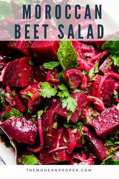 a white plate topped with beets and cilantro