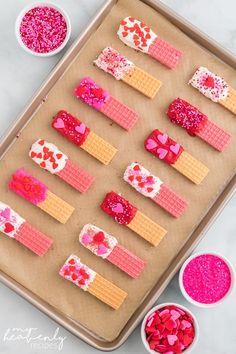 valentine's day treats on a baking sheet with sprinkles