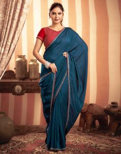 Rama Blue Stone Work Embellished Silk Saree  Rama Blue Stone Work Embellished Silk Saree is a luxurious and elegant piece. The rich silk fabric drapes beautifully, creating a flowing and sophisticated look. The intricate stone work, which can feature floral motifs, geometric patterns, or abstract designs, adds a touch of opulence and sparkle.  Features Of Rama Blue Stone Work Embellished Silk Saree  Traditional Handloom Craft  Intricate Gold Brocade Work  Durability and Longevity   Size Fit  The Festive Blue Art Silk Pre-draped Saree, Festive Floor-length Blue Pre-draped Saree, Festive Blue Floor-length Pre-draped Saree, Blue Dola Silk Pre-draped Saree With Pallu, Festive Blue Tussar Silk Pre-draped Saree, Blue Dola Silk Pre-draped Saree With Zari Weaving, Blue Bollywood Draped Blouse Piece, Blue Draped Blouse Piece With Zari Work, Blue Draped Bollywood Blouse Piece