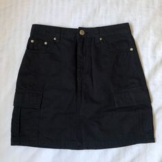 Black Cargo Skirt Brand H&M Never Worn No Flaws! Tag Says Size 2 Dm For Measurements High Waist Black Skort With Pockets, Black Casual Skort With Pockets, Casual Black Skort With Pockets, Black Skort With Pockets, High Waist Black Mini Skirt With Pockets, High Waist Black Cargo Skirt With Pockets, Black High Waist Cargo Skirt With Pockets, Black Mini Skirt With Pockets, Trendy Black Cotton Cargo Skirt