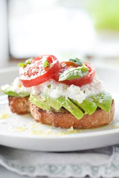 a close up of a plate of food with tomatoes and lettuce on it