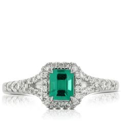 Emerald ring with 1/5 carat total weight of diamonds, in 14K white gold. Emerald Ring With Center Stone In 14k White Gold, 14k White Gold Emerald Cut Halo Ring, 14k White Gold Diamond Ring With Baguette Cut, Vvs Clarity Emerald Cut 14k White Gold Diamond Ring, Diamond White 14k Gold Baguette Cut Diamond Ring, Diamond White Emerald Ring With Diamond Accents In Platinum, Fine Jewelry Emerald Cut Diamond Ring With Accents, Platinum Emerald Ring With Diamond Accents In Diamond White, Formal Emerald Ring With Pave Diamond Setting