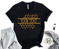 a t - shirt with the words your text on it next to some clothing and accessories