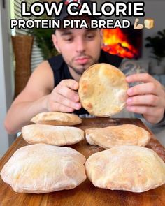 a man is making bread on a wooden table with the words low calorie protein pita bread