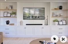 a living room filled with lots of white furniture