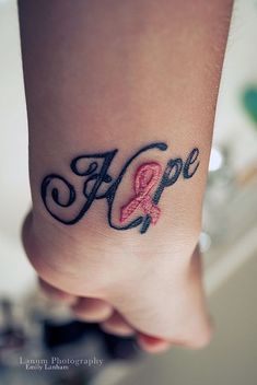 a woman's foot with a pink ribbon on it and the word hope written in cursive writing