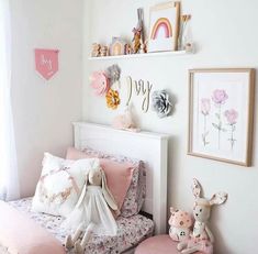 a child's bedroom decorated in pink and white