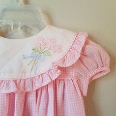 "- This gorgeous vintage dress is ready to be worn again! It is pink gingham with short sleeves and buttons at back of neck. There is a large, round collar trimmed in gingham ruffles. The white on collar is embroidered with pink flowers with greens and a bow. So perfect for Easter. size is: 9 months (2 available) Length: 13.75\" + 3\" hem allowance" Embroidered Baby Clothes, Baby Dress Embroidery, Pink Gingham Dress, Dress Ruffles, Toddler Dresses, Vintage Baby Clothes, Dress Embroidery, Frocks For Girls