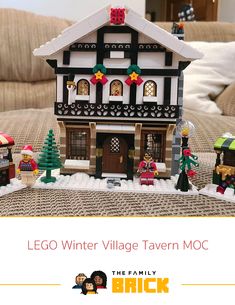 the lego winter village tavern moc is set up in front of a couch with christmas decorations on it