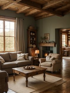 a living room with two couches and a coffee table in front of a fireplace