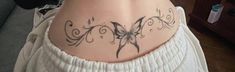 a woman with a butterfly tattoo on her lower back and upper half of her body