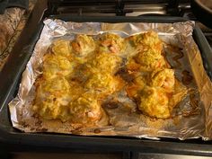 some food is sitting on top of tin foil in the oven and ready to be cooked