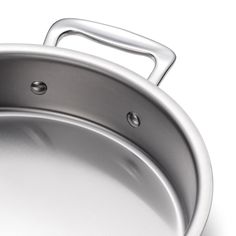 an empty silver pan with handle on a white background, close up view to the bottom