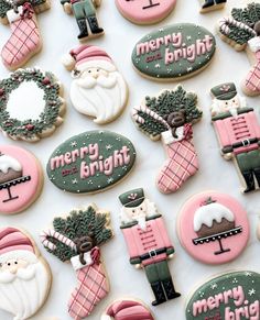 decorated christmas cookies are displayed on a table