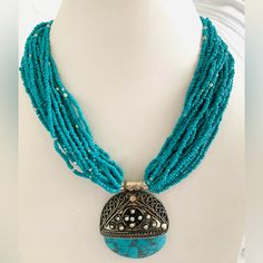 a necklace with turquoise beads and silver accents