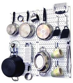 a peg board with pots and pans on it