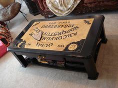 a wooden table with writing on it in front of a couch and several other furniture