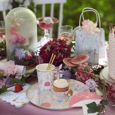 a table topped with lots of cake and cupcakes