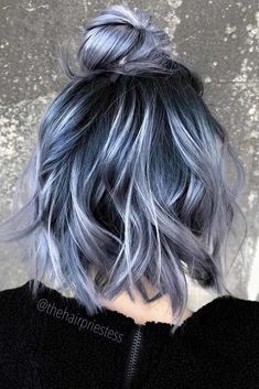 a woman with blue and grey hair is shown from the back