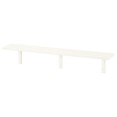 a white shelf sitting on top of a wall