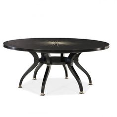 a black table with metal legs and a star design on the top, against a white background