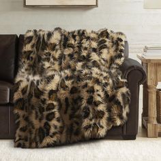 a couch with a leopard print blanket on it