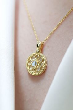 Sofia Sailormoon Floral Moonstone Pendant Necklace has a lovely gold flower pattern with a moonstone in the middle. Made with 18k gold vermeil. ◊ 18k Gold Vermeil ◊ Necklace length approximately measures 44 cm, pendant 1.1 cm wide ◊ Delivered in our signature Pina Blue Box, perfect for gifting yourself and loved ones! Gold Moonstone Jewelry With Moon Phase, Delicate Moonstone Gold Jewelry, Delicate Gold Moonstone Jewelry, Gold Moonstone Pendant Necklace, Gold Moonstone Round Necklaces, Round Gold Moonstone Necklaces, Celestial Gold Moonstone Necklace, Celestial Gold Necklace With Moonstone, Intricate Moonstone Jewelry For Gift