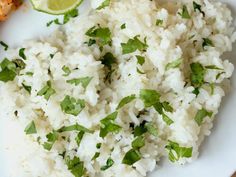 white rice with cilantro and lime served on a plate next to chicken breast