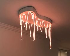 a light that is hanging from the ceiling with icing on it's side