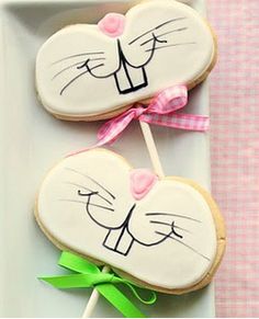 two decorated cookies sitting on top of a white plate