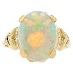 Size: 7 1/4 Sizing Fee: Up 2 sizes for $35 or Down 2 sizes for $30 Metal Content: 14k Yellow Gold Stone Information Natural Opal Carat(s): 3.73ct Cut: Oval Cabochon Stone Note: Australian Total Carats: 3.73ct Style: Cocktail Solitaire Features: Heart Shoulder Detailing Measurements Face Height (north to south): 9/16" (13.7mm) Rise Above Finger: 11/32" (8.7mm) Weight: 5.2 Grams Stamps: 14k Condition: Pre-Owned Professionally cleaned, polished, and tested to guarantee metal content. Rise Above, La Face, Gold Stone, Natural Opal, Oval Cabochon, Solitaire Ring, Karate, Metallica, Jewelry Rings