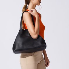 Material: Pebbled leather Color: Black Height: 28 cm 11.0 inch Length: 35 cm 13.8 inch Depth: 16 cm 6.3 inch Weight: 1 Kg 2.21 Lb. Designer Totes, Every Woman, Pebbled Leather, Timeless Pieces, Zipper Pocket, Timeless Design, Leather Straps, Unique Style, Handles