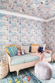 a living room filled with furniture and colorful wallpaper